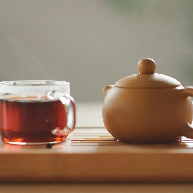 Une théière avec une tasse de tisane